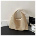 Large beige woven straw tote bag with cream leather trim in a summer resort style - White