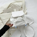 Minimalist white leather mini backpack featuring stylish beaded drawstring and flap closure - White