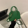 Green shell bag with crocodile pattern and gold hardware for crossbody carry - Green