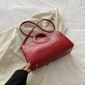 Deep red crocodile pattern handbag with unique circular cutout handles and slim shoulder strap - Red