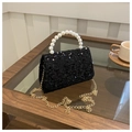 Detail of black sequin handbag featuring white faux pearl handle and gold chain strap - Black
