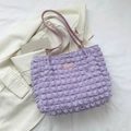 Lavender popcorn fabric shoulder bag with fashion label on stylish white blazer - Purple