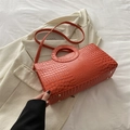 Fashionable orange crocodile textured tote bag with round handle and gold studs - Orange