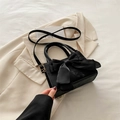 Elegant black crossbody bag with large satin bow accent and stylish matte leather finish - Black