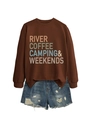 Flat lay of brown coffee camping sweatshirt paired with distressed blue denim shorts - Coffee