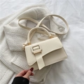 Minimalist cream white top-handle bag with a large square buckle and shoulder strap - White
