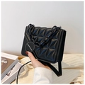 Chic black quilted crossbody bag with stylish acrylic chain and macaron buckle detail - Black