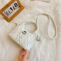 White quilted denim crossbody bucket bag with fringe trim and metal turn-lock closure - White