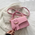 Pink minimalist faux leather crossbody handbag with gold buckle on white fabric - Pink