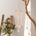 Golden geometric crystal suncatcher with pink beads creating rainbow light on wall - Fairy Pyramid Suncatcher