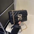 Classic black quilted shoulder bag with golden geometric clasp and chain strap - Black