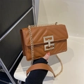 Brown quilted leather crossbody bag with V-shaped stitching and gold chain strap - Brown