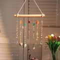 Handmade agate suncatcher with natural crystals and wood hanger showing rainbow light - Starry Wood Stick
