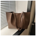 Mocha brown leather tote bag with vertical stitching detail on a white windowsill - Coffee