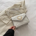Elegant white quilted crossbody bag with golden heart-shaped crown buckle detail - White