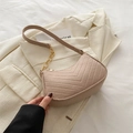 Chic beige chevron quilted crossbody bag with gold chain strap on stylish blazer - Khaki