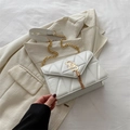 Elegant off-white quilted shoulder bag with gold 'SS' logo and chain strap - White