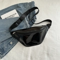 Glossy black patent leather chest bag with adjustable strap on a denim jacket - Black