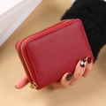 Red PU leather card holder with dual zippers and litchi texture held by a model - Red