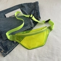 Neon green transparent PVC crossbody chest bag with adjustable strap on denim background - Yellow