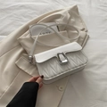 Chic white quilted crossbody bag with wave texture and silver metallic buckle - White