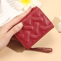 Women's compact red bi-fold wallet featuring heart embroidery and leather wrist strap - Red
