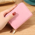 Pink faux leather card holder with dual zippers and gold hardware in a handheld view - Pink