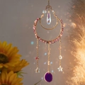 Golden moon suncatcher with purple crystal chips and agate slice on warm floral background - Shadow Moon Suncatcher