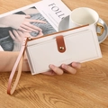 Minimalist cream white long wallet with brown trim and secure zipper closure for women - White