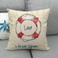 Detail of nautical cushion cover with red lifebuoy print and Love text on linen fabric - Lifebuoy Style