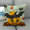 Close-up of linen Halloween pillowcase with pumpkin and bat prints on a grey sofa - Halloween Element Mix Style (6)