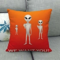 Detail of linen alien pillow case with We Want You slogan on a gray sofa - Three Aliens With Slogan Style (15)