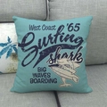 Linen pillowcase with surfing shark print in teal blue on a grey fabric sofa - American Vintage Surfing Shark Style (9)