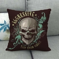 Linen alien skull pillow cover with green baroque patterns on a grey sofa - Baroque Foliage Skull Style (12)