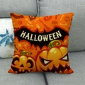 Orange Halloween throw pillow cover with pumpkin and bat prints on a grey sofa - Orange Pumpkin and Bat Style (17)