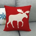 Red linen star pillowcase with white reindeer silhouette on a modern grey fabric sofa - Red Background White Moose Silhouette Style (2)