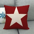 Close-up of red linen pillowcase featuring a large cream star on a grey sofa background - Red Background White Large Star Style (4)