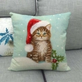 Detailed close-up of a Christmas linen pillow cover featuring a festive cat on a gray sofa - Tabby Cat Wearing Christmas Hat (16)