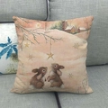 Linen pillowcase detail showing cute rabbits and snowy winter scene on grey sofa - 45x45cm / Rabbits in Snow Style (10)