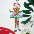 Detail eines Weihnachts-Plüschbären mit langen Beinen und Navidad-Schild für den Baum - Bär