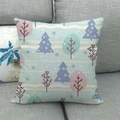 Detail of linen Christmas pillowcase with Nordic winter trees on a gray sofa - Nordic Winter Trees (2)