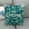 Close-up of linen Christmas pillowcase with snowflakes and Merry Christmas text on sofa - Dark Green Snowflake Art (15)