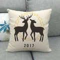 Linen Christmas pillowcase with reindeer silhouette on a gray fabric sofa - Double Elk Wreath Style