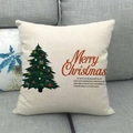 Close-up of linen Christmas pillowcase with Merry Christmas text on a grey fabric sofa - 45x45cm / Red Merry Christmas Text (7)
