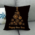 Detailed shot of a black linen Christmas tree pillow cover on a grey sofa - 45x45cm / Black Base Gold Snowflake Tree (8)