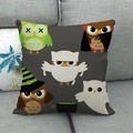 Linen Halloween pillowcase featuring five cartoon owls in spooky costumes on a grey sofa - Halloween Cartoon Owls (4)