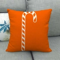 Linen Christmas pillow case with orange candy cane pattern on a dark grey sofa - Orange Candy Cane Style (13)