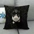Close-up of cat series linen pillowcase showing Tuxedo cat print on gray sofa - Square / Cow Cat Looking Up