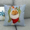Close-up of a Christmas cushion featuring a puppy in a red stocking on a linen sofa - Puppy in Christmas Stocking (7)
