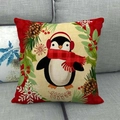 Detail of Christmas penguin linen pillowcase with red earmuffs on a grey fabric sofa - Cartoon Penguin